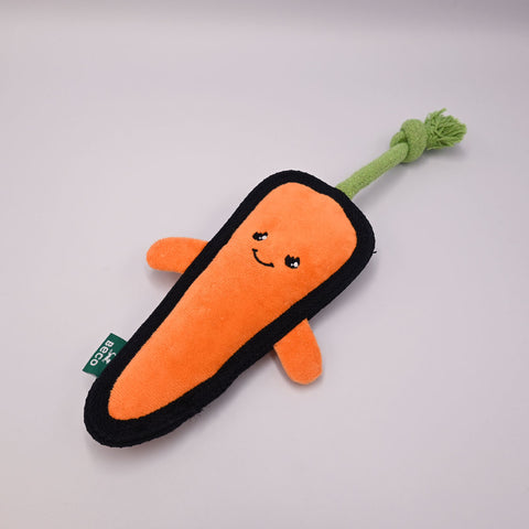 Beco carrot-shaped toy with a smiley face on a gray background.
