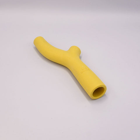 Beco's Yellow silicone stick-shaped toy on a light Grey background.