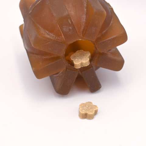 Brown pet chew toy with treats inside on a white background