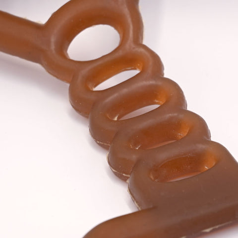 Natural rubber tug dog toy detail on a light White background.