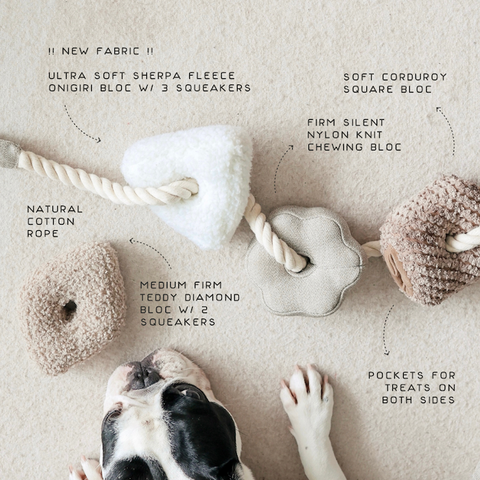 Dog toys with text describing features on a beige background, with a dog's paws visible.
