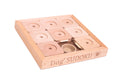 A wooden Dog Sudoku puzzle game set on a white background, featuring a light natural wood box engraved with 'Dog SUDOKU' and nine matching wooden puzzle pieces inside.