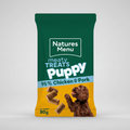 Natures Menu puppy treats packaging with a green top and yellow bottom, featuring chicken and pork ingredients.