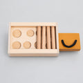 Wooden puzzle with circular pieces in a box on a white background