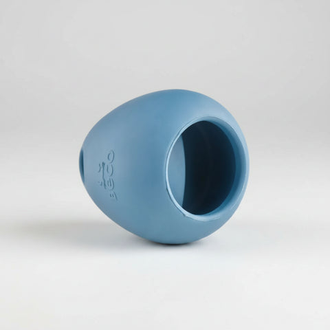 Blue rubber ball with a central hole on a white background