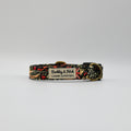 Dog collar with floral pattern and visible brand label on a white background