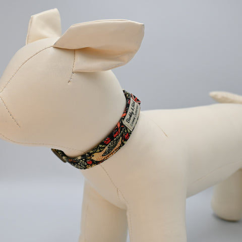 Beige dog mannequin wearing a floral-patterned collar on a light Grey background.