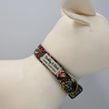 Dog collar with floral pattern and brand name on a mannequin neck.