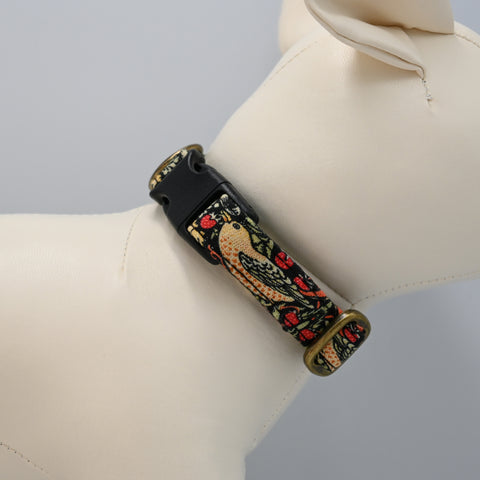 Decorative collar strap with bird design on a dog mannequin against a neutral background.