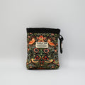 Floral-patterned pet treat pouch with a black base on a light neutral background.