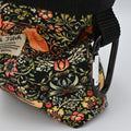 Floral-patterned bag with a carabiner on a neutral background.