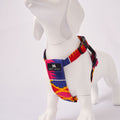 White dog model wearing a colorful Dakar harness on a light Grey background - Side view