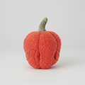 Knitted pumpkin toy on a white background