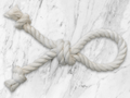 White rope tied in a knot on a marble surface