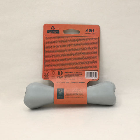 Gray dog chew toy with an orange label on a beige background