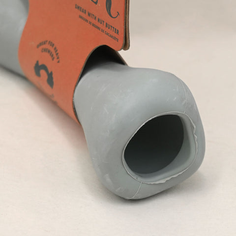 Gray dog chew toy with an orange label on a white background