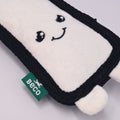 White and black toy with a smiley face design and Beco label on a light Grey background