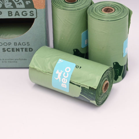 Green rolls of Beco dog poop bags with a visible brand label on a white background.