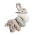 Set of dog toys including a rope, chew toy, and plush ball on a white background