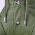 Close-up of a green jacket with buttons and drawstrings on a light gray background
