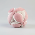 Pink and white knitted ball toy on a white background