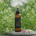 Brown spray bottle with black label on a white background