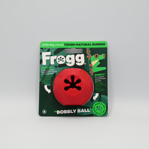 Red dog toy with a central hole and in original packaging.
