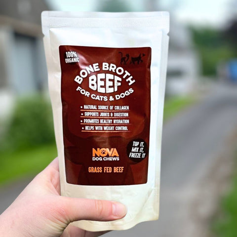 Hand holding a package of Bone Broth Beef for cats and dogs by Nova Dog Chews.