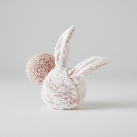 Pink bunny dog toy with a fluffy ball on a white background