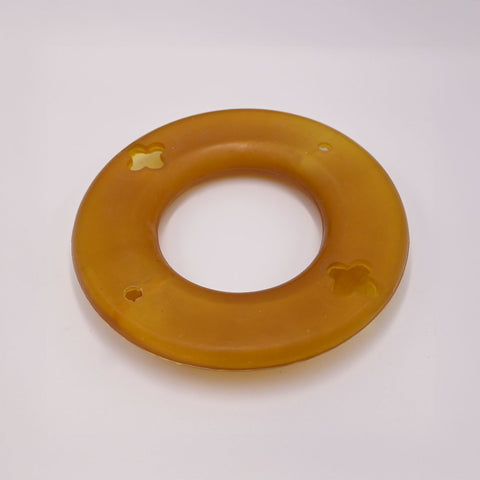 Round amber-colored Dog frisbee toy upside down.