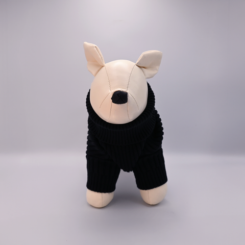 Stuffed animal toy with a black outfit on a gray background