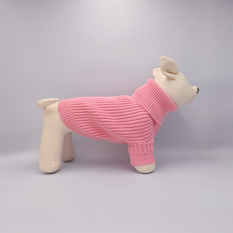 Dog toy wearing a pink sweater on a gray background