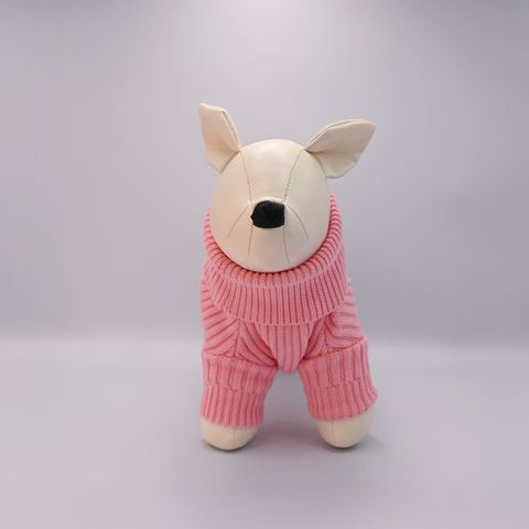 Stuffed animal toy wearing a pink knitted outfit on a gray background