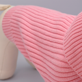 Close-up of a pink knitted fabric with a neutral background