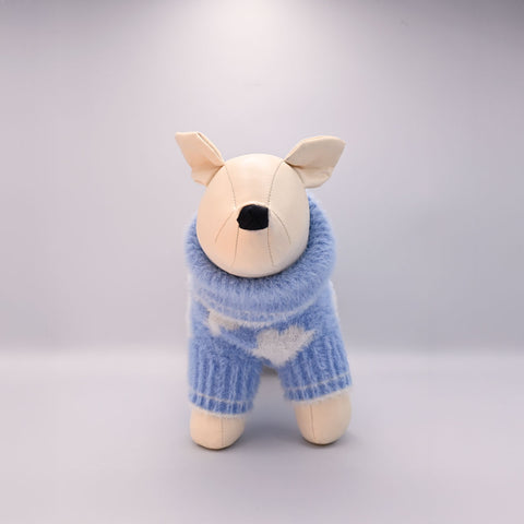 Dog manequin with a blue sweater on a light grey background