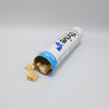 Open tube of treats with visible brand name on a gray background